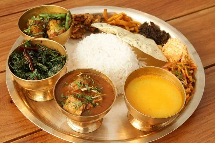 Thakali Thali served with steamed rice, meat, vegetable curry, and dal-traditional Nepali food from Mustang region