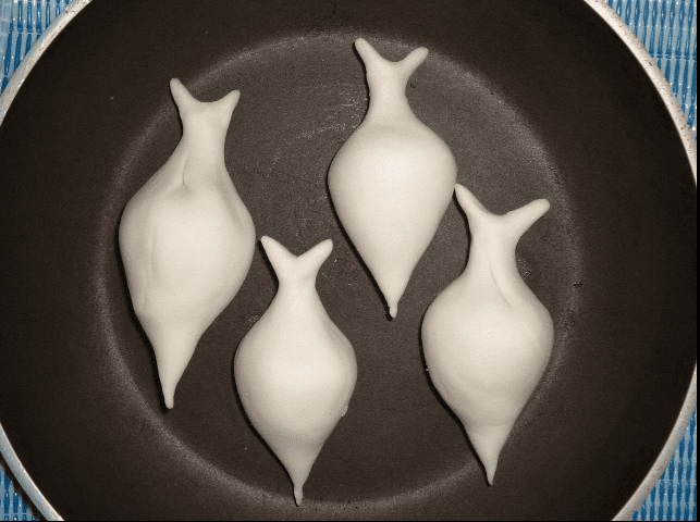 Yomari - Traditional Newari steamed dumplings served in a pan